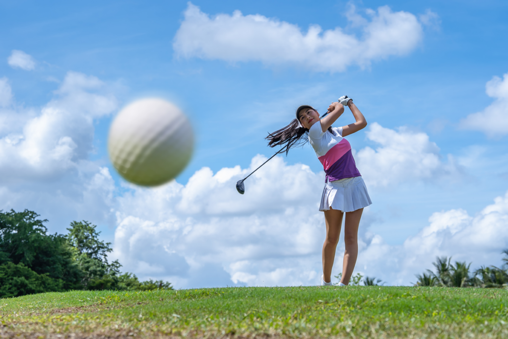 Female golfer hitting driver