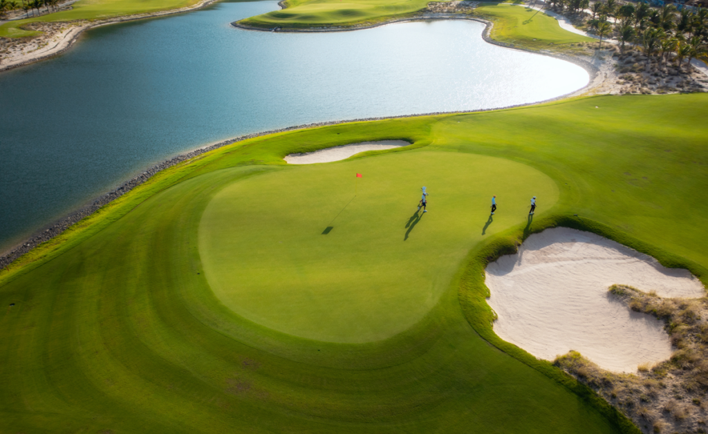 Aerial shot of golf course with water surrounding green