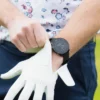 Golfer putting on glove with G6 on wrist