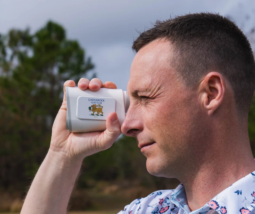 Golfer looking through PRO X rangefinder