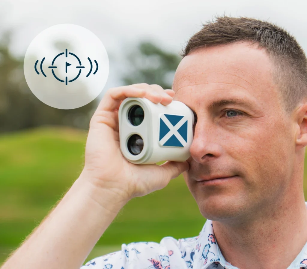 Golfer looking through PRO X rangefinder with Scotland flag plate