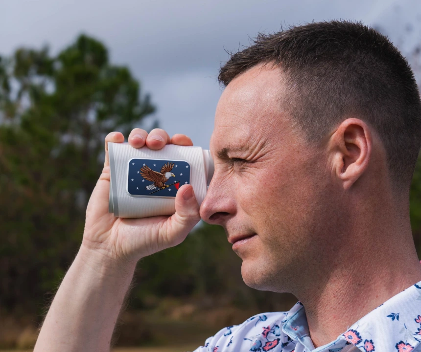 Golfer looking through the PRO X rangefinder with the Eagle plate